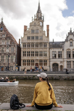Woman Tourist Looking at Graslei Architecture in Ghent Belgium