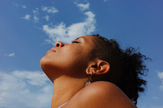 Woman looking up at the sky while enjoying a sunny day