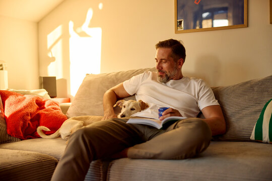 Portrait of a man rests with his dog at home