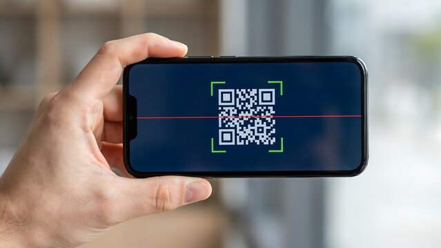 Close up photo of a hand holding a smartphone scanning a digital QR code for quick information access