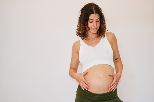 Pregnant woman holding belly