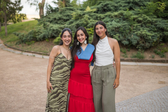 Group Portrait of Three Young Women at Graduation Event