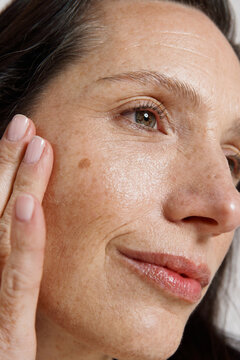 Woman Touching Her Face and Examining Her Skin 