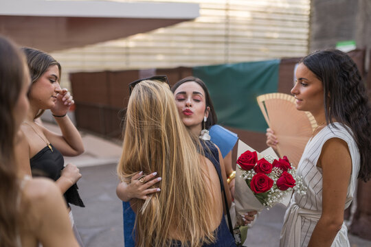 Graduated Young Woman Embracing Her Friend at Celebration Event