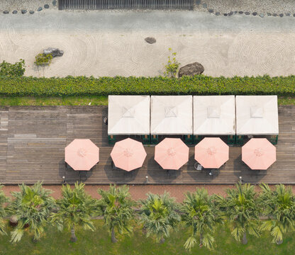 Aerial View of Serene Outdoor Cafe with Pink Umbrellas