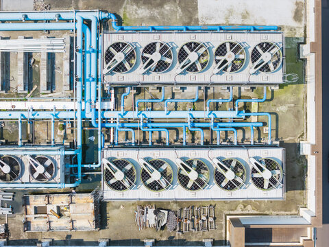 Industrial Rooftop HVAC Cooling Towers and Blue Pipes