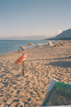 Warm Beach Scene With Sunbathers Relaxing Near the Water