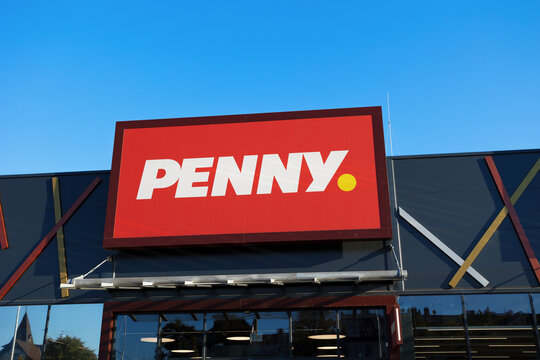 Krnov, Czech Republic, Czechia - August 15. 2026: Penny supermarket and shop storefront with store sign. Logo and brand of retail company. Blue sky as copy space.