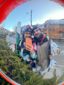 Skiers Mirror Selfie in Snow Village
