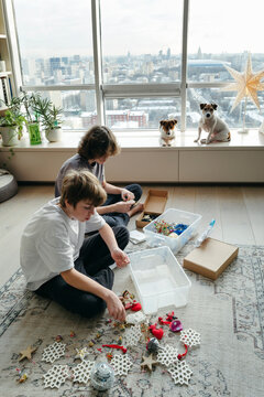 Kids Preparing for Holiday Decorations in a Cozy Living Room