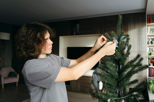 Decorating the Holiday Tree With Care and Joy in a Cozy Living Room