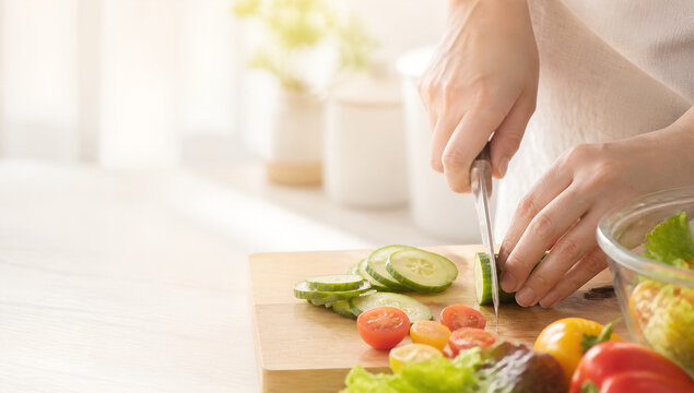 Hands Preparing Fresh Vegetable Salad in Bright Home Kitchen
