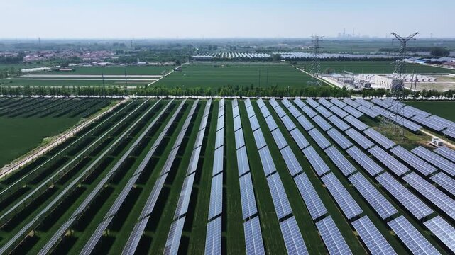 Aerial view of large-scale ground-mounted photovoltaic power station array in green farmland