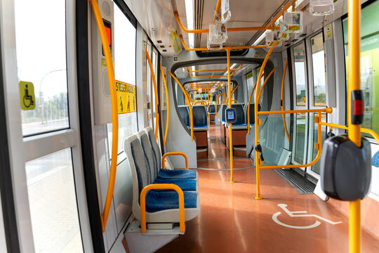 Empty interior of a modern public transport tram with accessible seating