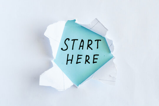 Start Here Handwritten Message Revealed Through Torn Paper, Beginning and First Step Concept
