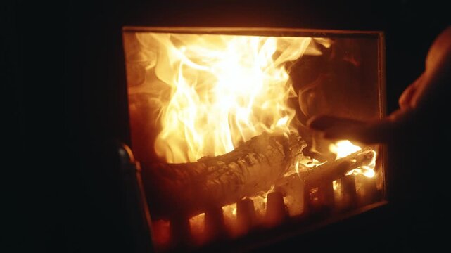 Slow Motion Close-Up Hand Warming by a Burning Fireplace