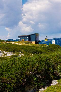 Dachstein Krippenstein, iconic bright yellow cable car cabins and gondolas that transport visitors up the mountain slopes in Obertraun, Austria.