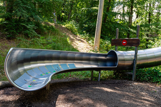 Binz, Ruegen, Mecklenburg-Western Pomerania, Germany-July 23, 2026: Stainless steel slide at the treetop walk