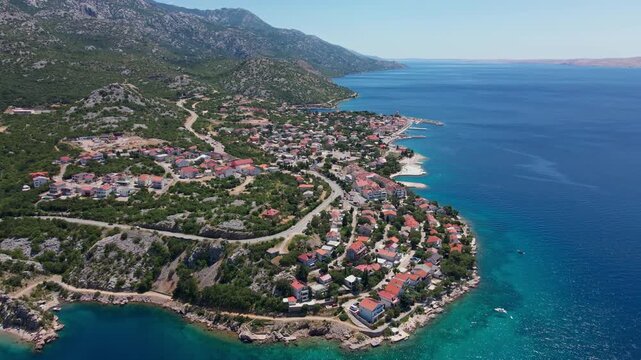 Aerial view of a coastal village between mountains and the sea