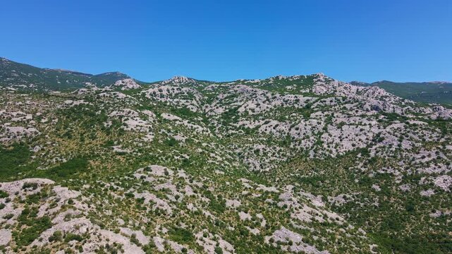 Rocky mountain landscape covered with low green shrubs