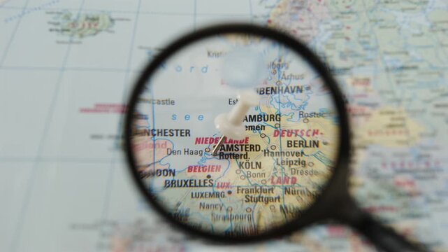 Exploring the map with a magnifying glass focusing on a specific location marked with a colored pin