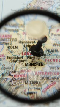 Magnifying glass highlights location marked on printed map