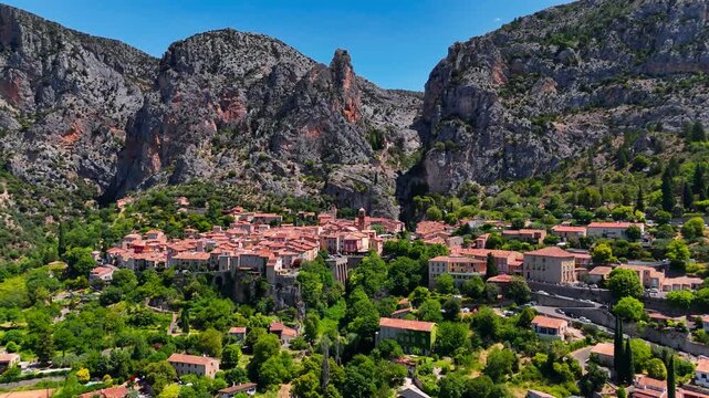Aerial drone view Village de Moustiers-Sainte-Marie among the mountains. Provence-Alpes-Cote d'Azur region. High quality 4k footage. 