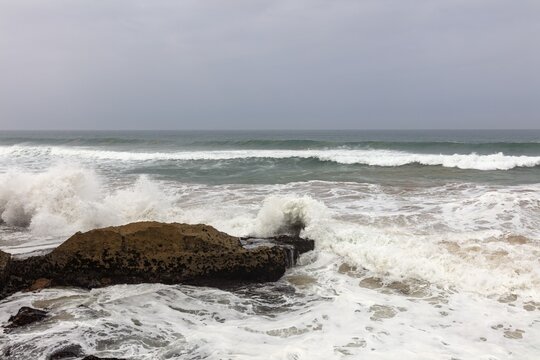 Waves beat against the rocky coast