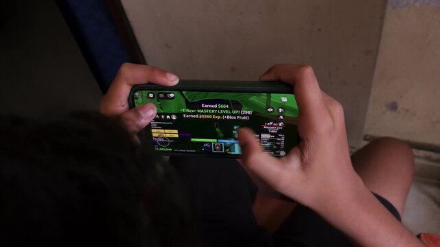 Close-Up of Indian Childrean Playing an Online Video Game on Smartphone, Mobile Gaming with Touchscreen Controls, Digital Entertainment, Gaming Technology, Esports, Smartphone Gameplay and Interactive