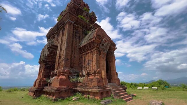 Panning shot revealing ancient Banh It Cham main and south towers with scenic valley view in Quy Nhon Vietnam