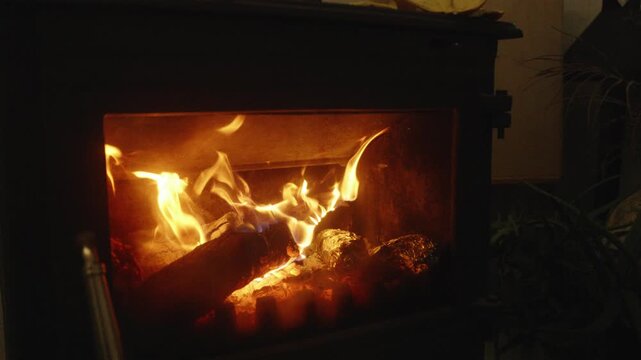 Slow Motion Close-Up of Burning Firewood and Flickering Flames in a