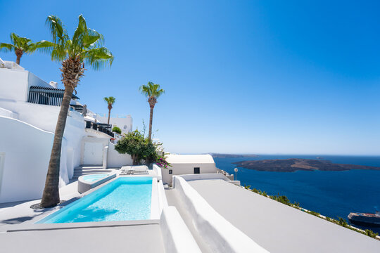 White architecture in Santorini island, Greece. Swimming pool with blue water. Blue sea and the blue sky at sunny day.