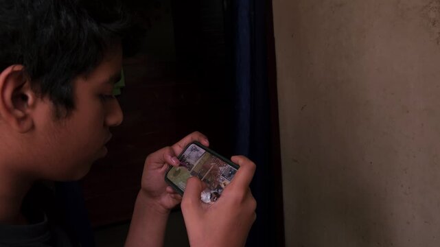 Close-Up of Indian Childrean Playing an Online Video Game on Smartphone, Mobile Gaming with Touchscreen Controls, Digital Entertainment, Gaming Technology, Esports, Smartphone Gameplay and Interactive