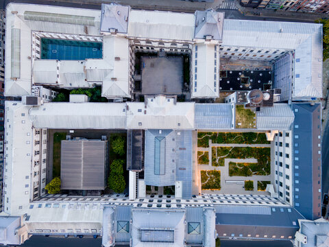 Top down aerial view of the geometric rooftops and inner courtyards of a large Ghent University building in Ghent Belgium an abstract architectural pattern seen directly from above.
