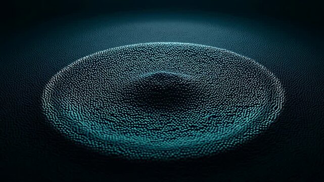 Concentric ripple forming across dense field of tiny spheres under teal rim light, creating raised circular wave, subtle central depression, dark moody abstract surface