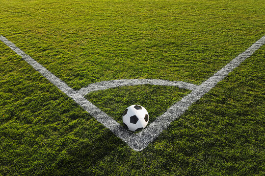 a soccer ball on the green grass on the line on corner in soccer stadium. corner kick.