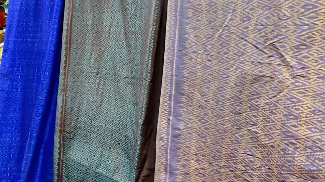 Assortment of traditional woven silk cotton fabric cloths with exotic pattern on display sale, Hand Stitched Textile Industry, Asian Fashion Craft, Thai Exquisite Clothing, Elegant Embroidery