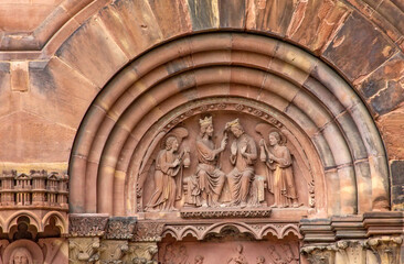 Fototapeta premium Gothic stone relief depicting the Coronation of the Virgin Mary by Christ, surrounded by angels, on the south transept portal of Strasbourg Cathedral in Strasbourg, France.