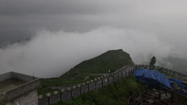 Giddha Pahar View Point in Kurseong, West Bengal, India, Scenic Himalayan Mountain Landscape Covered with Mist and Clouds, Green Hills, Foggy Weather, Mountain Tourism and Travel Background