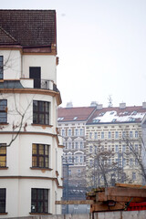Apartment building dominates. Historic facade rises. Bare trees frame. Construction appears below. © VladyslavShcherbakov
