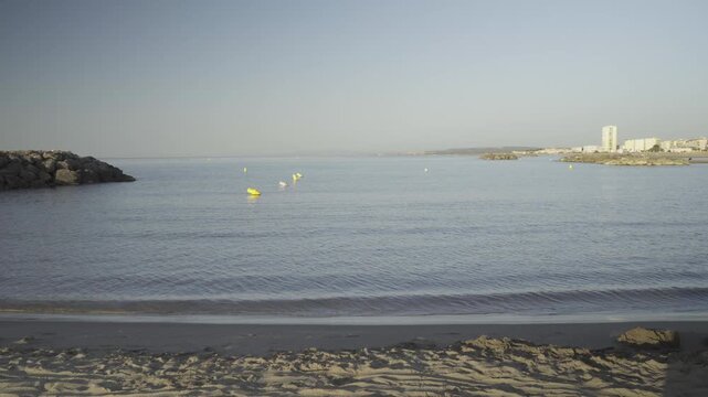 France, Valras Plage 08.08.2026 &mdash; Calm Sea and Sandy Beach with Stone Breakwater at Resort Coastline