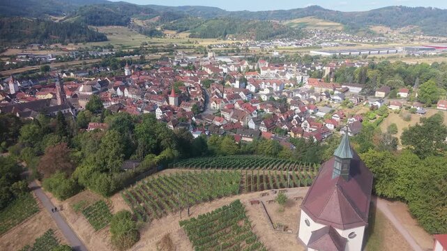 Picturesque Jakobuskapelle chapel overlooking the historic town of Gengenbach. Green vineyards and rolling hills of the Black Forest