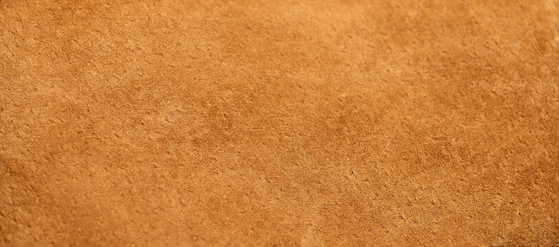 Suede texture background close up. Brown suede leather surface backdrop, genuine leather, top view. Suede of animal skin. Texture for design 