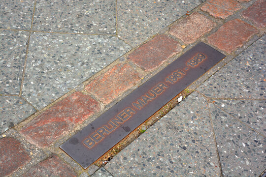 BERLIN GERMANY: Sign on the road to show the place of the old Berlin Wall.  East German government surrounded the Western sectors of Berlin with barbed wire, cutting them until 1989
