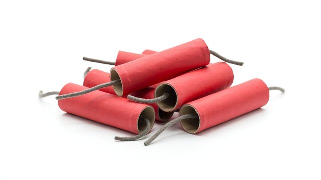 Pile of red firecrackers with fuses isolated on a white background for holiday celebration.