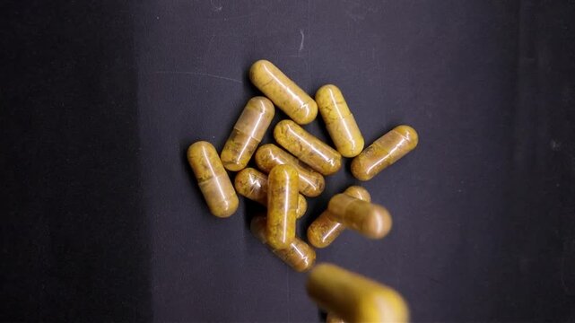 yellow pills in medicine , full slow motion , algal dha