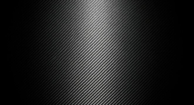 A sleek carbon fiber texture with diagonal weave pattern in shades of gray and black. Perfect for modern tech backgrounds, industrial designs, and contemporary graphics with depth.