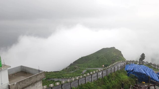 Giddha Pahar View Point in Kurseong, West Bengal, India, Scenic Himalayan Mountain Landscape Covered with Mist and Clouds, Green Hills, Foggy Weather, Mountain Tourism and Travel Background