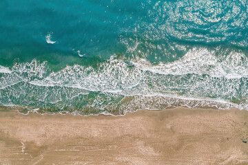Patara, Kas. Top down aerial view of turquoise waves crashing on the sandy coastline of Patara beach.  Antalya, Turkey. © thehakanarslan