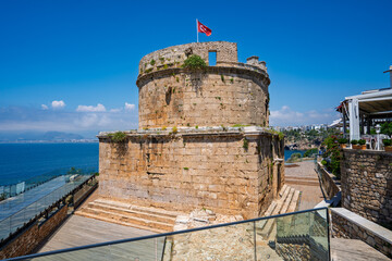 Fototapeta premium Hidirlik Tower with the Mediterranean Sea and coastal promenade in old town Antalya, Turkey.